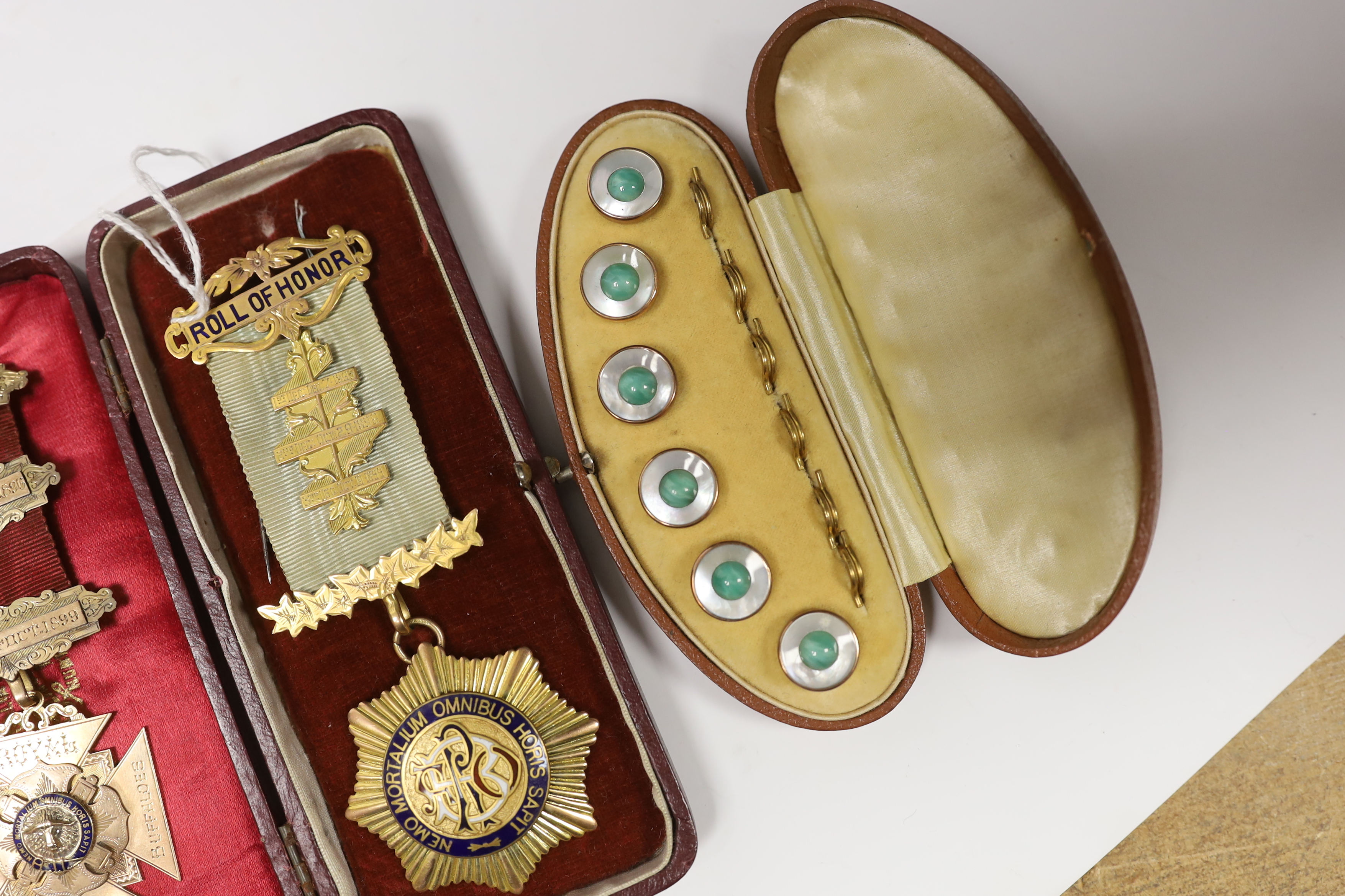 A late Victorian 9ct and enamel masonic jewel and a later Edwardian 9ct gold and enamel masonic jewel, gross weight 46.5 grams, together with a cased gilt metal and paste dress stud set